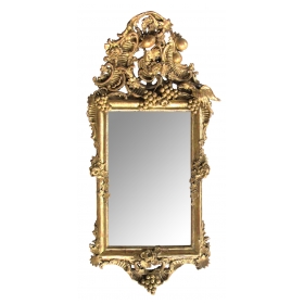 an ornately carved french rococo gilt-wood mirror with exuberant crest