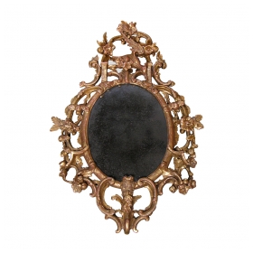 a well-carved english george ii carved giltwood oval-form mirror