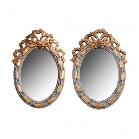 a charming pair of french rococo style gray painted and parcel-gilt carved wood oval wall mirrors