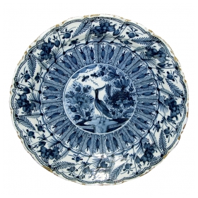 a boldly-scaled dutch delft blue and white charger with lobed rim