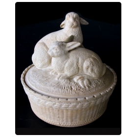 a charming french beige-colored pottery basket-weave bowl with cover adorned with two rabbits