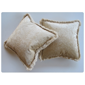 a sumptuous pair of ivory cut-velvet silk pillows with cotton fringe