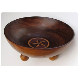 a richly-patinated english rosewood treenware bowl with inlaid star motif