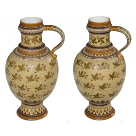 a good quality pair of german mettlach pottery ewers; each with impressed maker's mark; dated 1893