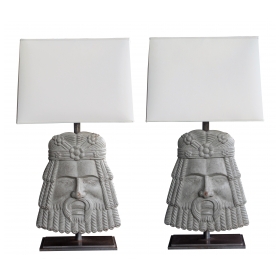 a well-carved and stylized pair of italian romanesque style gray painted wooden masks now mounted as lamps