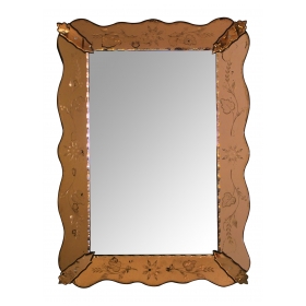 a shapely italian 1930's mirror with etched peach-colored surround