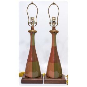 a handsome pair of american orange and olive green ceramic bottle-form lamps