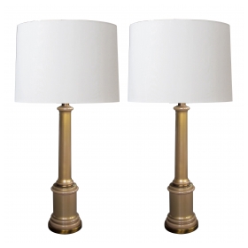 a good and stylish pair of hollywood regency mid-century columnar tan cased-glass lamps by paul hanson