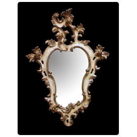 a fanciful venetian rococo revival ivory painted and parcel-gilt cartouche-shaped mirror