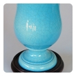a striking and robust pair of french art deco turquoise crackle-glazed urns now mounted as lamps