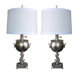 a stylish pair of american art deco brushed-nickel plated lamps with dolphin support