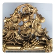 an ornately carved french rococo gilt-wood mirror with exuberant crest