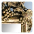 an ornately carved french rococo gilt-wood mirror with exuberant crest