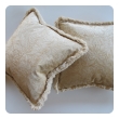 a sumptuous pair of ivory cut-velvet silk pillows with cotton fringe