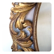 a well-carved italian baroque style oval gilt-wood mirror