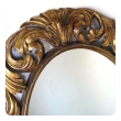 a well-carved italian baroque style oval gilt-wood mirror