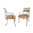 a stylish pair of 1940's hollywood regency ivory-painted and parcel-gilt klismos armChairss