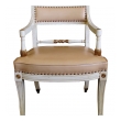 a stylish pair of 1940's hollywood regency ivory-painted and parcel-gilt klismos arm chairs