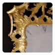 elegant and superbly-carved english george II giltwood mirror with elaborate foliate crest