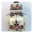 well-executed pair of delft polychromed hand-painted covered jars signed by the artist P. Verhoeve