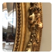 A French Napoleon III Giltwood and Composite Oval Mirror with Ribbon Crest and Oak Leaf Border