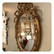 A French Napoleon III Giltwood and Composite Oval Mirror with Ribbon Crest and Oak Leaf Border