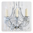 an elegant and graceful pair of italian 1960's cage-frame beaded 6-light chandeliers with tear drop crystal pendants