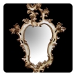 a fanciful venetian rococo revival ivory painted and parcel-gilt cartouche-shaped mirror