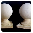 a massive and stately pair of french carved limestone orb-form garden elements
