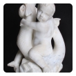 an expressive and well-carved italian rococo revival carrara marble niche fountain of a putti seated on a dolphin