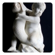 an expressive and well-carved italian rococo revival carrara marble niche fountain of a putti seated on a dolphin