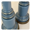 Side view of stepped glass bases with gilt bands and patinated brass feet