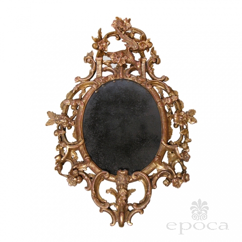 a well-carved english george ii carved giltwood oval-form mirror