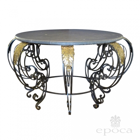 a curvaceous french rococo style wrought-iron circular center table with gray marble top