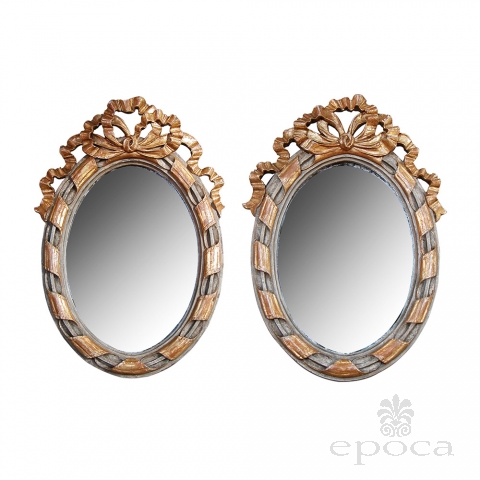 a charming pair of french rococo style gray painted and parcel-gilt carved wood oval wall mirrors