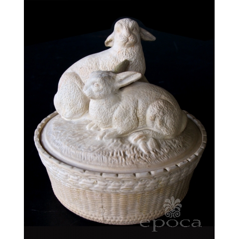 a charming french beige-colored pottery basket-weave bowl with cover adorned with two rabbits