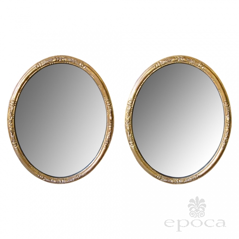 an elegant pair of french napoleon III carved giltwood oval mirrors