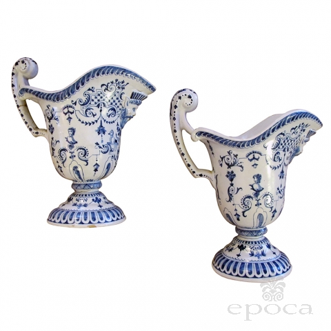 a good pair of french blue and white tin-glazed faience pitchers or ewers; probably Rouen