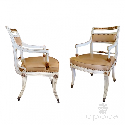 a stylish pair of 1940's hollywood regency ivory-painted and parcel-gilt klismos armChairss