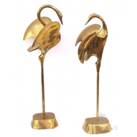 a graceful pair of stylized solid brass cranes