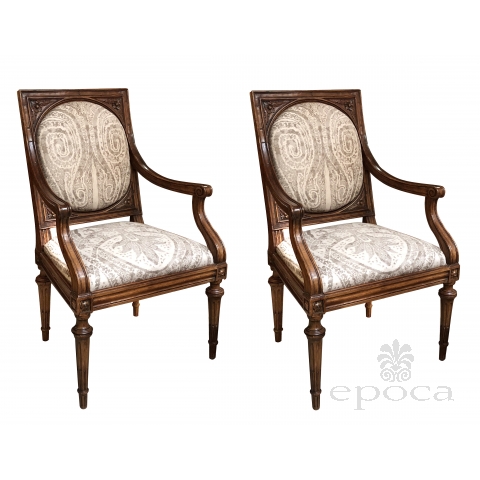 an exquisite and large-scaled pair of italian neoclassical carved walnut upholstered arm chairs